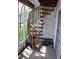 Outdoor wooden spiral staircase leading from a screened porch at 9722 Indian Key Trl # 116, Seminole, FL 33776
