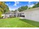 Spacious backyard featuring a well-maintained lawn, privacy fence, and access to an inviting screened-in pool area at 10513 Carrollview Dr, Tampa, FL 33618