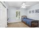 Light blue bedroom features a bed, window, and white trim, providing a comfortable and inviting space at 10513 Carrollview Dr, Tampa, FL 33618