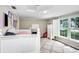 Cozy bedroom with natural light, a large window, and a white bed at 10513 Carrollview Dr, Tampa, FL 33618