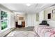 Comfortable bedroom featuring a built-in desk and large window at 10513 Carrollview Dr, Tampa, FL 33618
