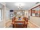 Charming dining room with a large wooden table, seating for eight, and unique wall decorations at 10513 Carrollview Dr, Tampa, FL 33618