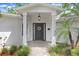 Welcoming front entrance featuring a covered porch and stylish front door with wreath at 10513 Carrollview Dr, Tampa, FL 33618