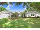 Charming single-story home with a well-manicured lawn and mature landscaping at 10513 Carrollview Dr, Tampa, FL 33618
