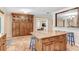 Kitchen showcasing a granite-topped island with seating and custom wood cabinetry at 10513 Carrollview Dr, Tampa, FL 33618