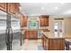 Spacious kitchen with granite countertops, wooden cabinets, and stainless-steel appliances at 10513 Carrollview Dr, Tampa, FL 33618