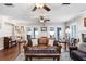 Comfortable living room with hardwood floors, leather couches, and natural light from the windows at 10513 Carrollview Dr, Tampa, FL 33618