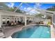 Relaxing screened-in pool area with outdoor seating, dining, and entertainment space, perfect for enjoying the Florida lifestyle at 10513 Carrollview Dr, Tampa, FL 33618