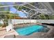 Beautiful pool within screened enclosure, slide, and bordered by lush landscaping offering a private oasis at 10513 Carrollview Dr, Tampa, FL 33618