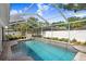 Inviting screened-in pool area with ample space for relaxation and leisure, surrounded by lush landscaping and a white fence at 10513 Carrollview Dr, Tampa, FL 33618