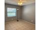 Comfortable bedroom with tile floors, ceiling fan, and natural light at 10811 Candlin Ct, Riverview, FL 33578