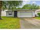 Charming one-story home with a well-maintained lawn and attached two car garage at 10811 Candlin Ct, Riverview, FL 33578