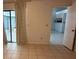 Bright living room with tile floors, access to the outside patio and view into the kitchen at 10811 Candlin Ct, Riverview, FL 33578