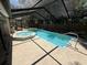 Beautiful, enclosed pool and spa features an extended, screened enclosure for year-round enjoyment at 10811 Candlin Ct, Riverview, FL 33578