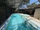 A screened-in pool and spa offer a refreshing escape in this backyard oasis at 10811 Candlin Ct, Riverview, FL 33578