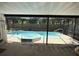Screened-in lanai featuring a pool and spa with fencing around backyard at 10811 Candlin Ct, Riverview, FL 33578