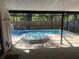 Relaxing screened-in pool area featuring a refreshing pool and hot tub, perfect for outdoor enjoyment at 10811 Candlin Ct, Riverview, FL 33578