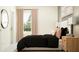 Comfortable bedroom featuring large window, neutral tones, and a stylish black comforter at 10826 Keato Beach Ct, Tampa, FL 33647