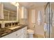 Bathroom features a vanity with granite countertop, decorative cabinets, shower, and tiled floor at 1270 Gulf Blvd # 1901, Clearwater Beach, FL 33767