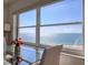 Dining area featuring a modern glass table and chairs with a stunning ocean backdrop at 1270 Gulf Blvd # 1901, Clearwater Beach, FL 33767