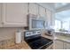 Modern kitchen featuring granite countertops, stainless steel appliances, and white cabinetry at 1270 Gulf Blvd # 1901, Clearwater Beach, FL 33767