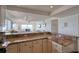 Bright kitchen showcasing granite countertops, white cabinets, and open layout to the living area with water view at 1270 Gulf Blvd # 1901, Clearwater Beach, FL 33767