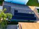 Aerial view of roof with solar panels, lush green surroundings, and nice paved driveway at 12720 Hampton Hill Dr, Riverview, FL 33578