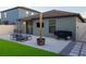 Backyard with outdoor seating, grill, and artificial turf, perfect for relaxation and entertainment at 12720 Hampton Hill Dr, Riverview, FL 33578