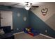 Playful bedroom featuring custom wall design, a ceiling fan, and a cozy bed at 12720 Hampton Hill Dr, Riverview, FL 33578