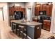Beautiful kitchen with an island, offering dark wood cabinets, granite countertops, and stainless appliances at 12720 Hampton Hill Dr, Riverview, FL 33578