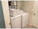 Functional laundry room with a washer, a dryer, shelving, and ample storage space at 12720 Hampton Hill Dr, Riverview, FL 33578