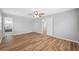 Spacious bedroom with wood-look flooring and ceiling fan at 1555 Newhope Rd, Spring Hill, FL 34606