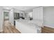 Bright kitchen with stainless steel appliances, marble countertops, and modern white cabinetry at 1555 Newhope Rd, Spring Hill, FL 34606