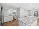 Modern kitchen featuring stainless steel appliances, marble counters, and wood-look floors at 1555 Newhope Rd, Spring Hill, FL 34606