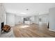 Spacious living area featuring hardwood floors, skylight, fireplace, and open to kitchen at 1555 Newhope Rd, Spring Hill, FL 34606