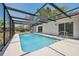 A screened-in pool in the backyard, perfect for relaxation and entertainment at 1555 Newhope Rd, Spring Hill, FL 34606