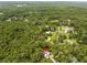 Beautiful aerial view of the property nestled within a serene, lush green wooded area at 1562 Oakhurst Dr, Brooksville, FL 34601