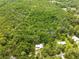 Home with silver metal roof surrounded by lush trees at 1562 Oakhurst Dr, Brooksville, FL 34601