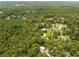 Charming aerial view of home nestled among lush trees, creating a private, secluded retreat at 1562 Oakhurst Dr, Brooksville, FL 34601