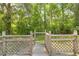 A backyard deck overlooks the yard, offering a natural and serene outdoor space at 1562 Oakhurst Dr, Brooksville, FL 34601