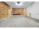 A basement features concrete floors, plywood walls, and fluorescent lighting at 1562 Oakhurst Dr, Brooksville, FL 34601