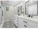 Bathroom featuring double sink vanity, modern fixtures, decorative tile floor, and a walk-in shower at 1562 Oakhurst Dr, Brooksville, FL 34601