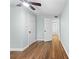 Bedroom with hardwood floors, neutral paint, two closets, and an open doorway at 1562 Oakhurst Dr, Brooksville, FL 34601