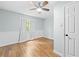 Cozy bedroom with light blue walls, wood-look floors, and a ceiling fan at 1562 Oakhurst Dr, Brooksville, FL 34601
