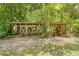 A large chicken coop resides in a lush backyard at 1562 Oakhurst Dr, Brooksville, FL 34601