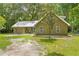 Charming home featuring an attached garage, spacious yard, and a silver metal roof at 1562 Oakhurst Dr, Brooksville, FL 34601