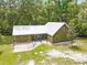 Aerial view of a charming home with an attached garage and a metal roof at 1562 Oakhurst Dr, Brooksville, FL 34601