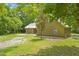Charming home featuring an attached garage, spacious yard, and a silver metal roof at 1562 Oakhurst Dr, Brooksville, FL 34601