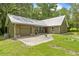 A well-kept home with a freshly mowed lawn and eye-catching silver metal roof at 1562 Oakhurst Dr, Brooksville, FL 34601