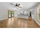 Open living space with hardwood floors, stone fireplace, and an open kitchen at 1562 Oakhurst Dr, Brooksville, FL 34601